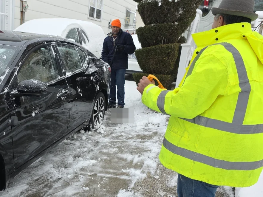 Greenscape crew clearing snow outside a Staten Island home